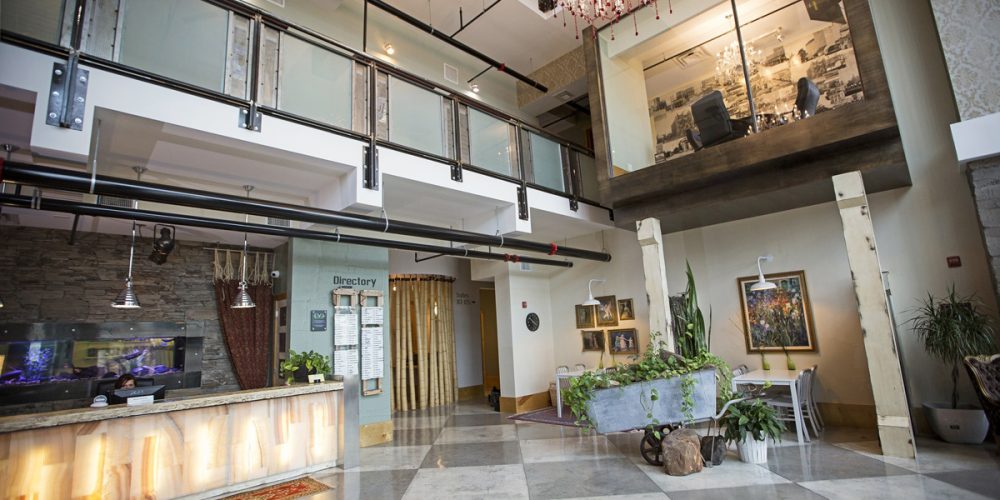 McKinney Office Building: interior view of lobby with large plate glass windows and glass balcony