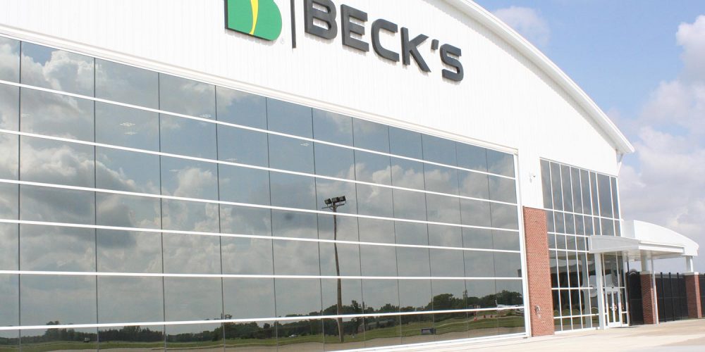 Exterior view of Becks Airport with large window wall and glass front entry; large Beck's Logo sign at top of building