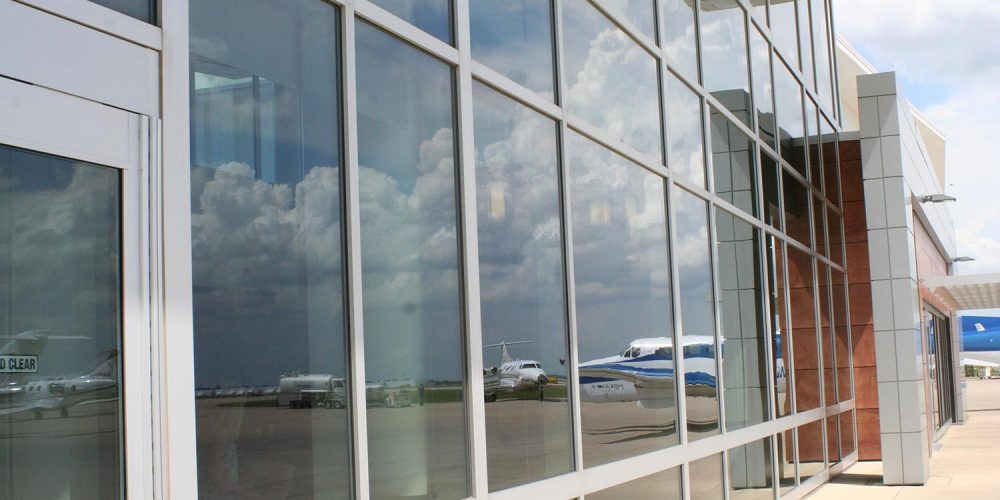 Exterior view of Hawker Beechcraft window wall with planes reflected in the glass